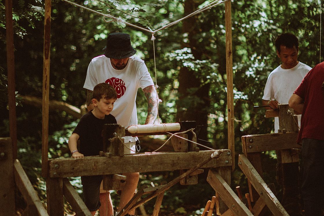 A boy and father learning woodcrafts together.